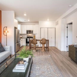 living room with coffee table and view of a kitchen