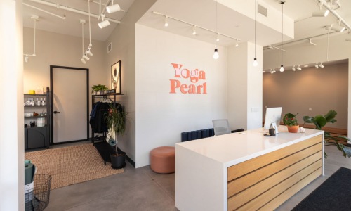 a reception desk with a sign seating and computer