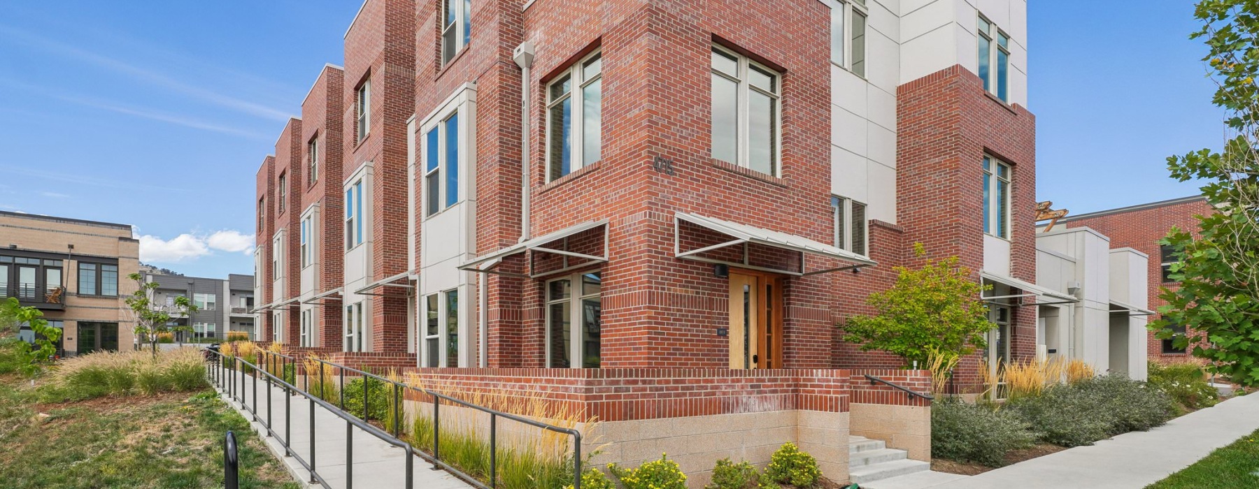 a brick building with a sidewalk steps and wheelchair ramp